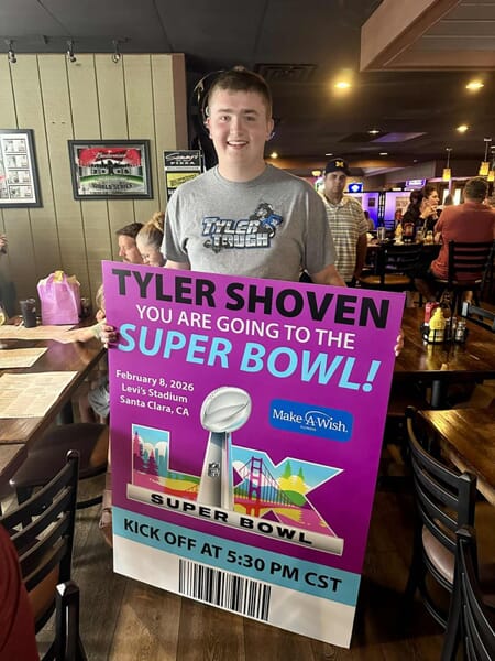 An image of Taylor holding a banner that says "You're going to the Super Bowl."